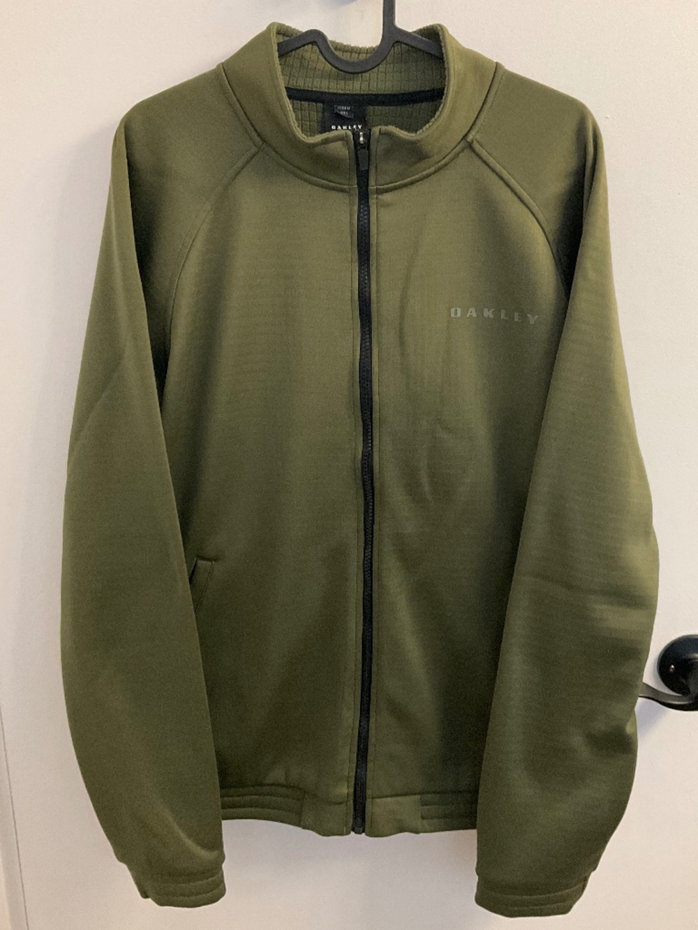 Olive green Oakley zip up track jacket with a large back logo, medium